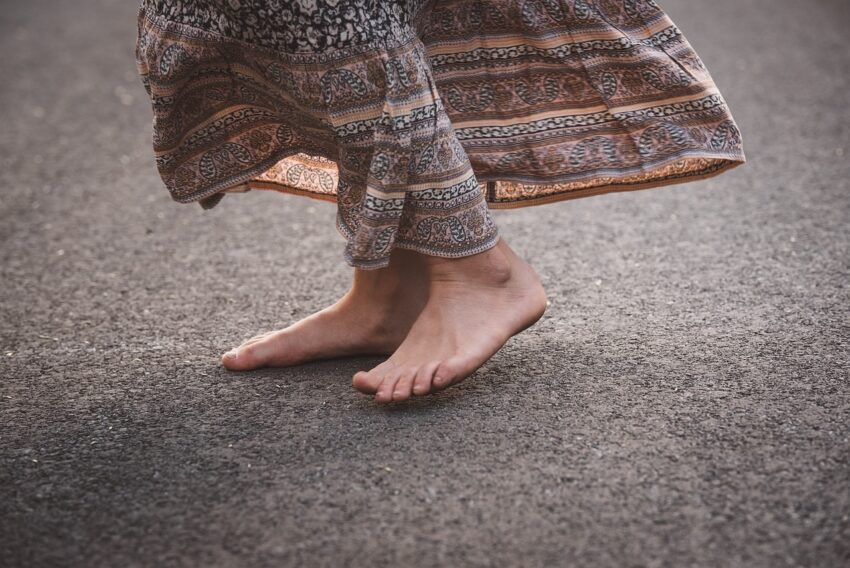 woman earthing - walking barefoot, coastal currents