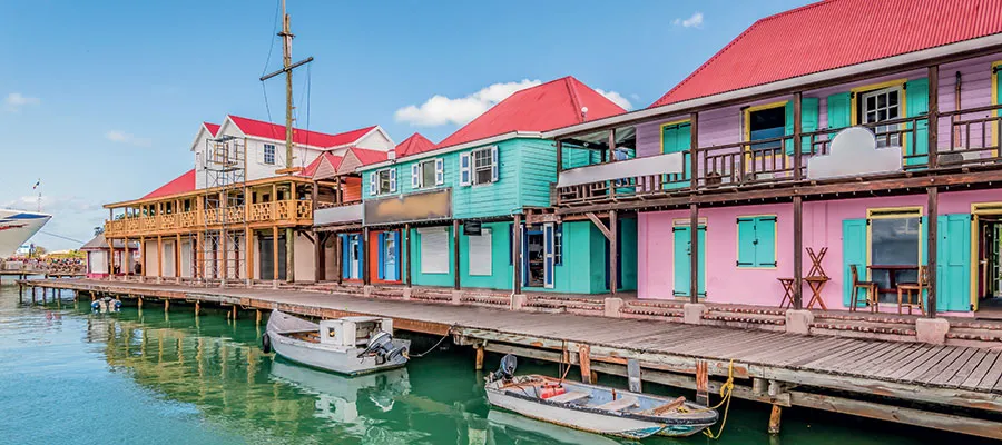 view of the antigua harbour with pink and green houses
